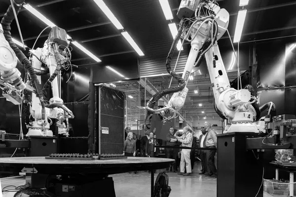 Robotic arms on a production floor
