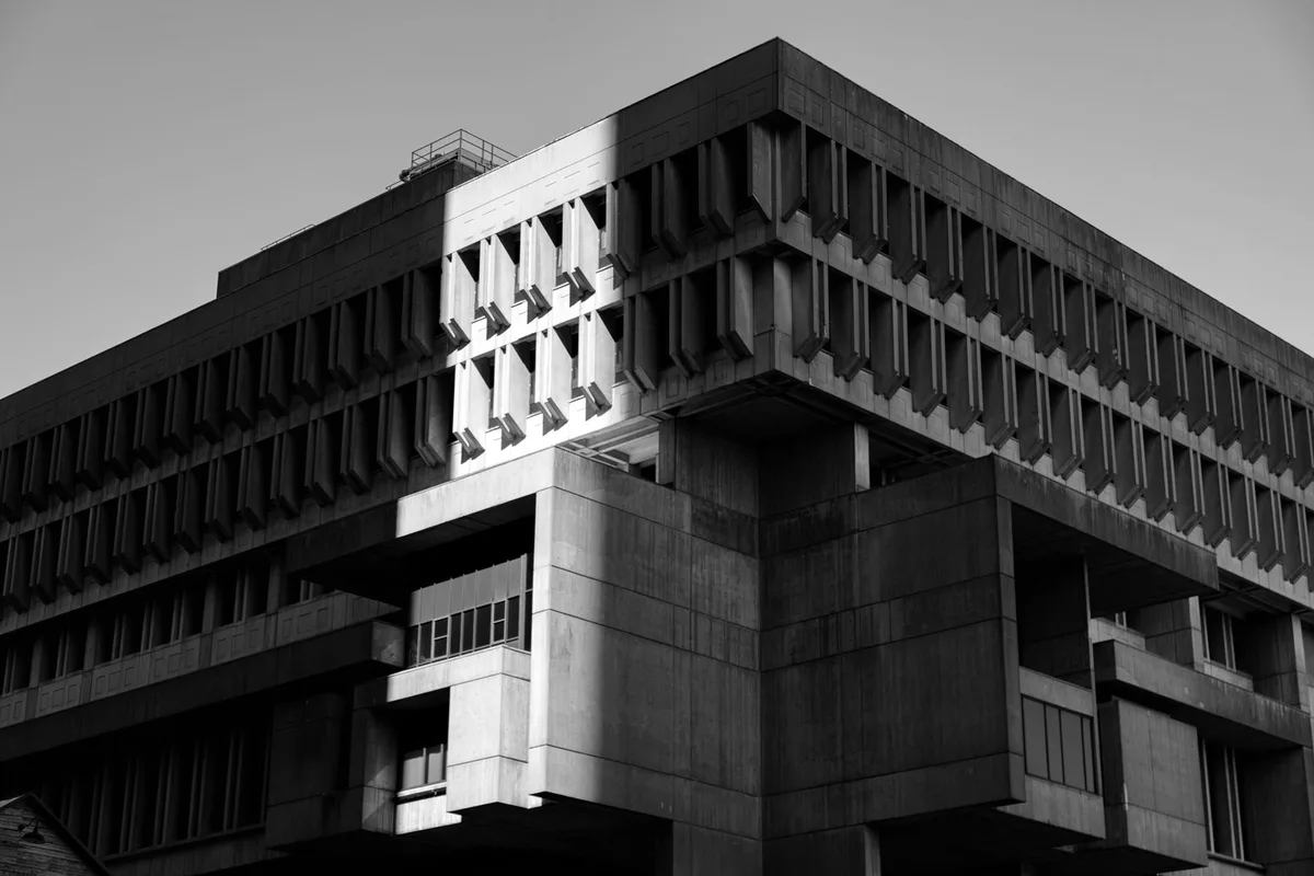 Façade of an institutional concrete building, brutalist architecture, viewed from below