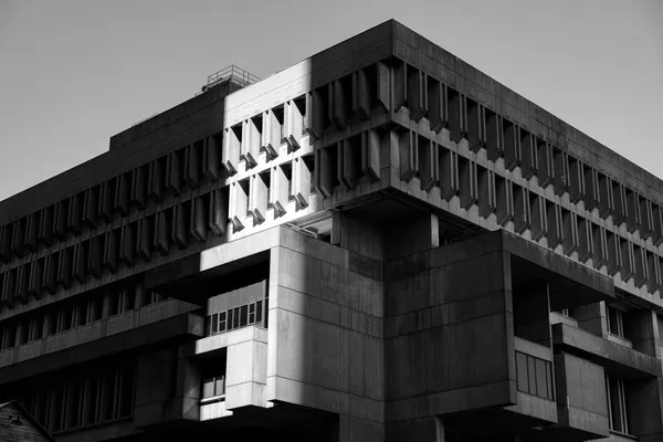 Façade of an institutional concrete building, brutalist architecture, viewed from below