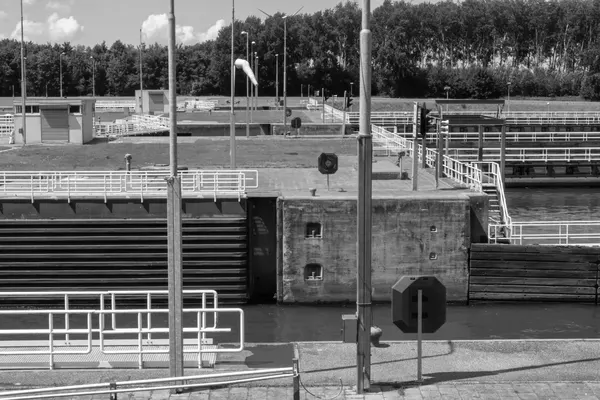 Le porte chiuse di una conca di navigazione su un canale, con la camera successiva oltre il muro, fotografia in bianco e nero