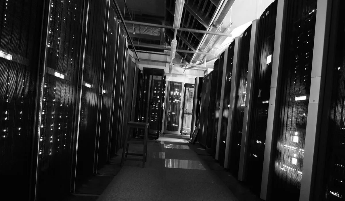 Corridor in a server room with rows of rack cabinets