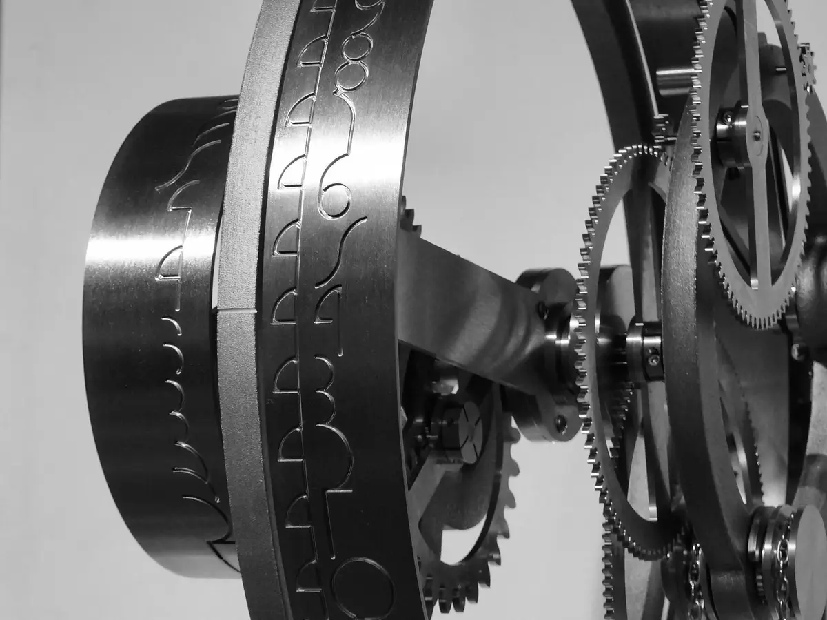 Precision mechanism with cog wheels and an engraved graduated ring, close-up detail, black-and-white photograph