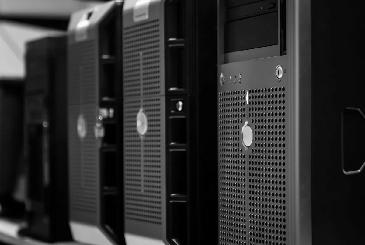 A row of computer servers in a rack, shot from the side in black and white