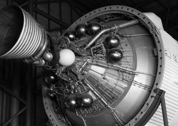 Close-up view of a vintage rocket engine, nozzle and spherical metal tanks, in black and white