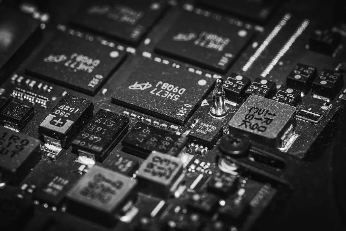 Black-and-white close-up of a circuit board, with chips and electronic components in tight focus